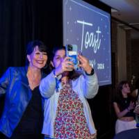 Philly smiles with a grad taking a selfie at Toast
